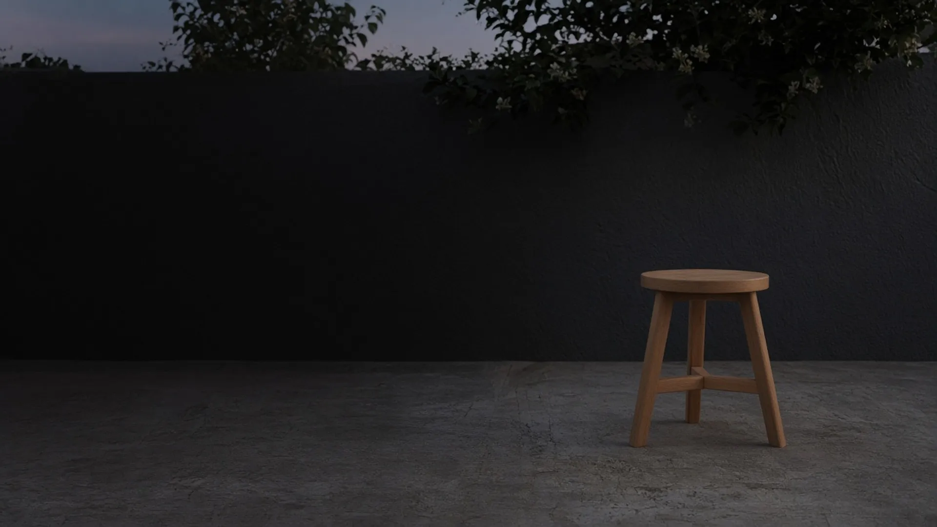 A smooth wood stool with a soft sheen standing on a concrete patio at dusk